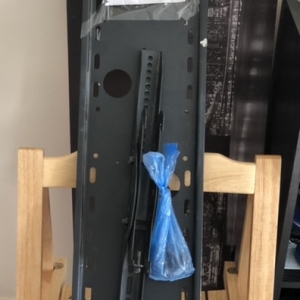 TV wall mount with fixing parts in the blue bag